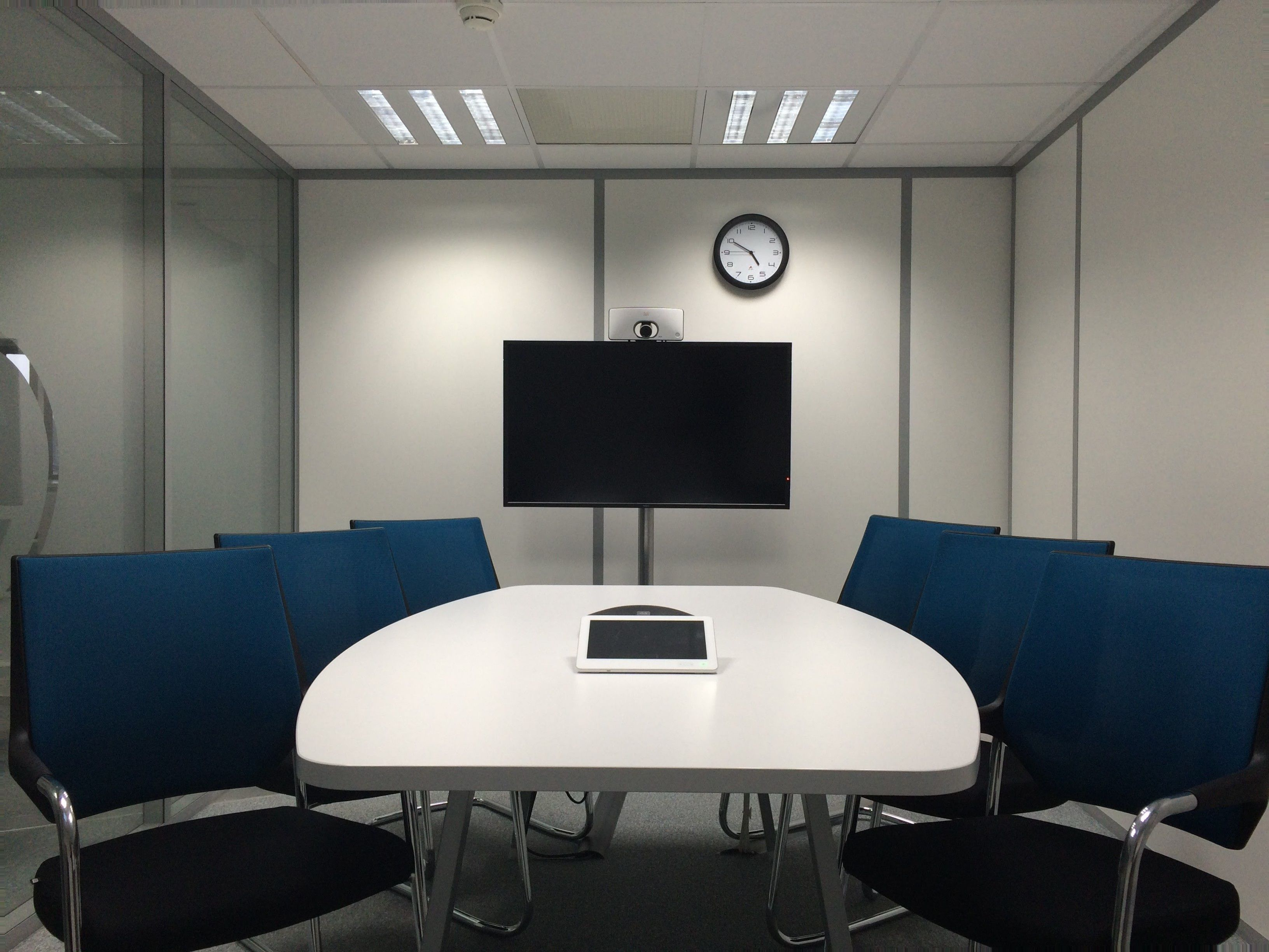 Integrated room-control touchscreen beside a professionally installed display